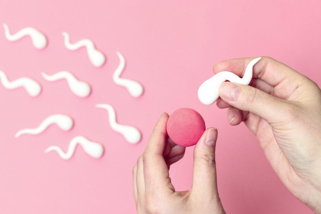 A playful, conceptual image showing sperm and egg models against a pink background. It represents the process of fertilisation, often used to explain how IVF works.